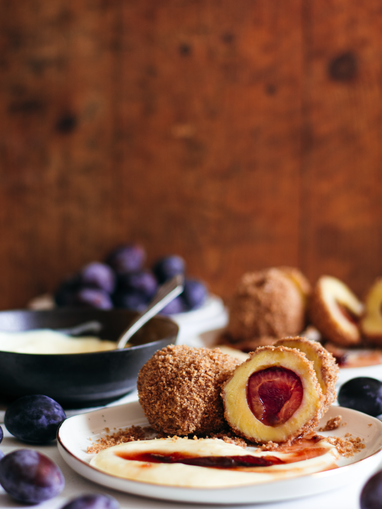 Plum dumplings Zwetschgenknödel dusted with sugar and cinnamon
