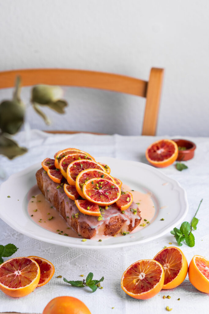 Slice of blood orange loaf cake with zesty glaze on top