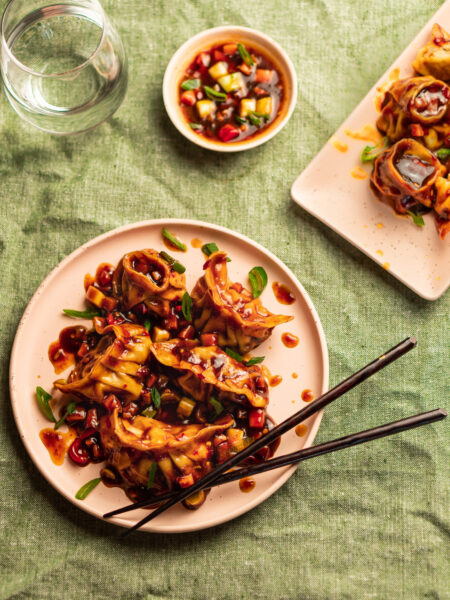 Indo-Chinese dumplings known as Manchurian momos, garnished with spring onions