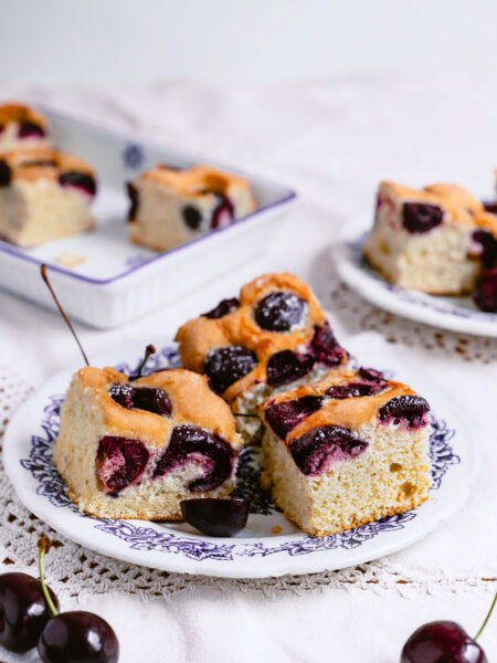 Romanian cherry sponge cake dusted with powdered sugar, freshly baked and ready to serve.