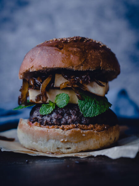 Spicy Indian burger with chutney, lettuce, and crispy potato patty.