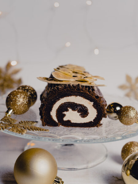 Festive chocolate Yule log roll cake, a traditional Christmas dessert.