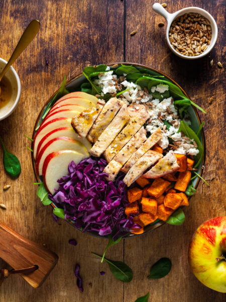 Harvest chicken salad with apples, nuts, and greens, perfect for a winter lunch.